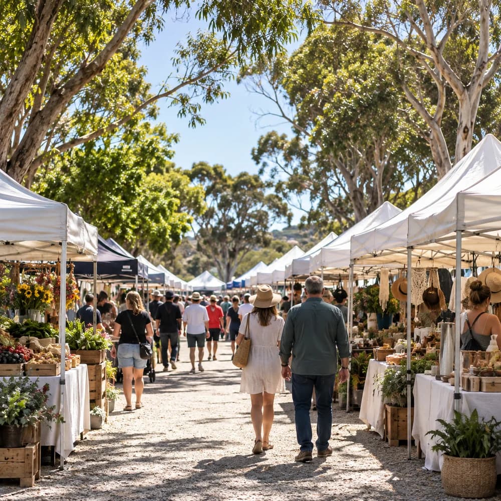 Illustrative local market with sunny stalls beneath leafy trees